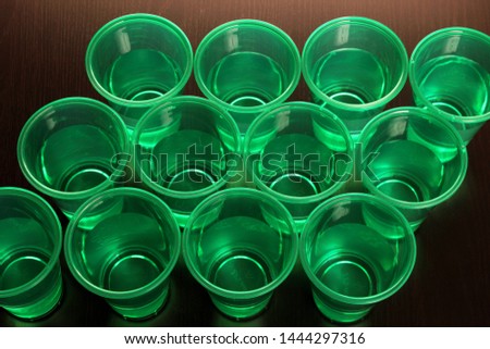 Cups of Water on Wooden Background