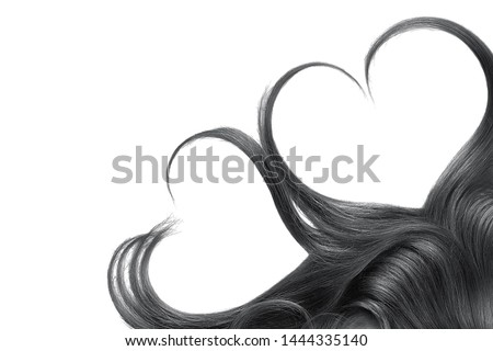 Black hair in shape of heart, isolated on white background