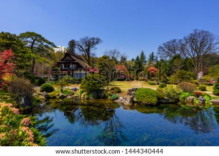 Traditional Japanese house with beautiful spring garden and clear pond with mountain Fuji or Fujisan near Oshino Hakkai village, Yamanashi, Japan. Famous travel between Lake Kawaguchiko and Yamanakako