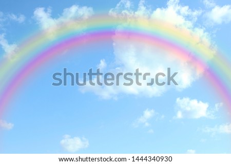 beautiful colorful rainbow in the blue sky with cloud as background