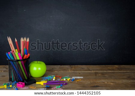 Education concept. Stationery various types were placed on the table, a chalkboard background with space to add text, images, prepared in advertising. Green Apple is a component.