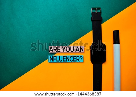 Are You An Influencer? text on top view color table background.