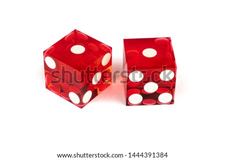 Two red glass luxury dices isolated against a white background. One and one with shadow, full clipping. Macro shooting, selective focus.