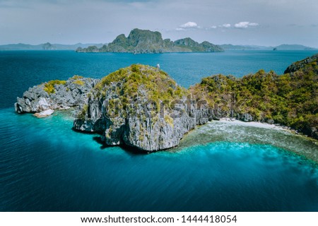 Aerial drone panorama picture of tropical paradise epic limestone Entalula Island. Miniloc island in background. El Nido, Palawan, Philippines
