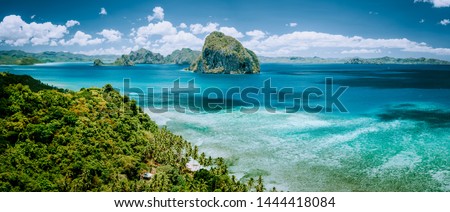Panoramic aerial view of tropical Palawan island with unique Pinagbuyutan island on horizon. El Nido-Philippines Southeast Asia Bacuit archipelago Royalty-Free Stock Photo #1444418084