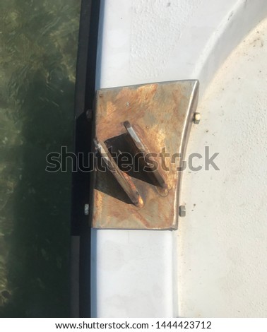 Metal old part of a white bow boat on summer sea