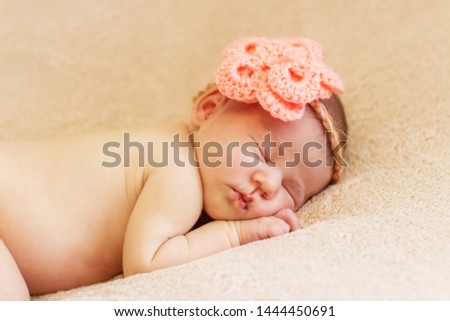Newborn sleeping baby on a blanket.