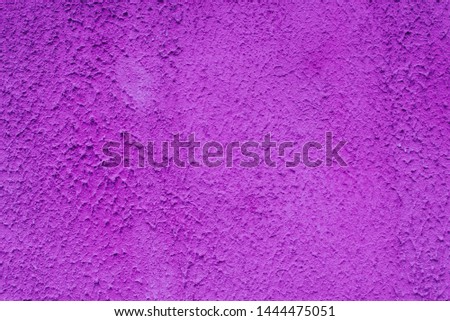 The brightly painted surface is covered with bright purple plaster. Background for copy space