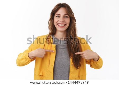 I what you look for. Attractive pleasant smiling happy young caucasian curly-haired girl pointing herself wanna participate volunteering suggesting own candidature standing white background bragging Royalty-Free Stock Photo #1444495949