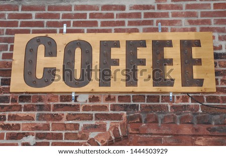 Coffee signboard posted in a brick wall