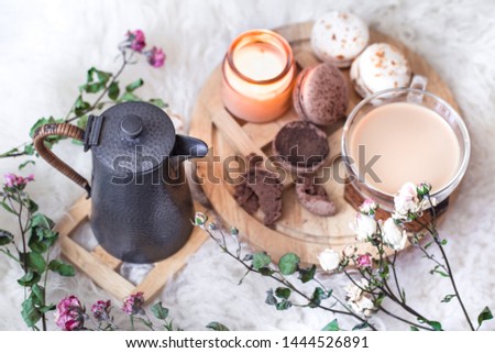 Romantic Breakfast with a Cup of hot drink and a teapot, with roses and macaroon dessert .