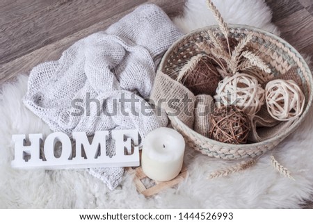 Cozy home still life with the inscription home and wicker basket with decor. The view from the top. The concept of home atmosphere and decor