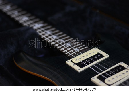 Electric guitar on a dark background.