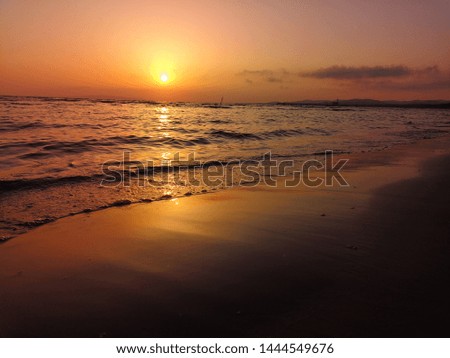 Amazing sunset with orange sky and sea waves background