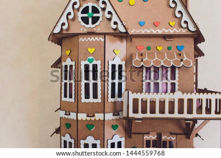 White wooden decorative houses on blue wall background. Toy houses in Christmas decor. The interior of the children's room.