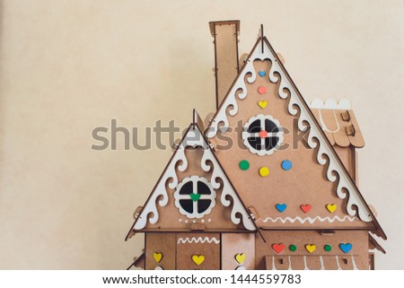 White wooden decorative houses on blue wall background. Toy houses in Christmas decor. The interior of the children's room.