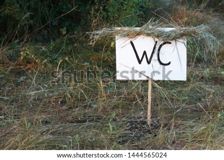 Simple design handmade wooden sign of toilet give direction to WC