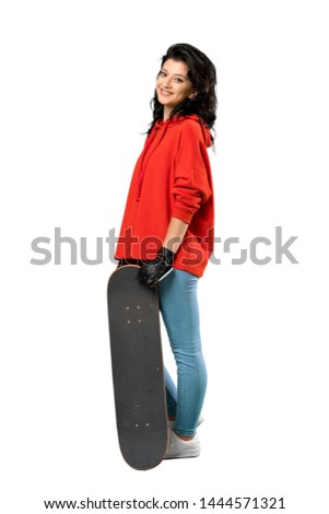 A full-length shot of a Young skater woman with red sweatshirt over isolated white background