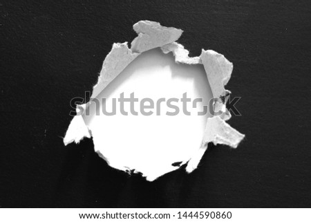 Torn hole and ripped of paper on white background