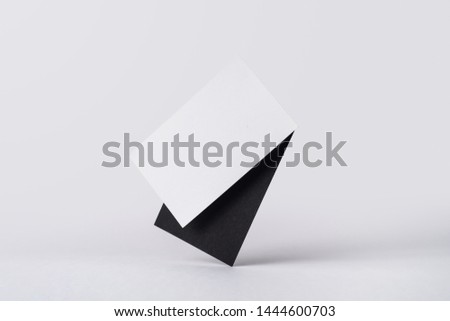 Design concept - front view of 2 surreal white and black business card float on mid air isolated on white background for mockup, it's real photo, not 3D render