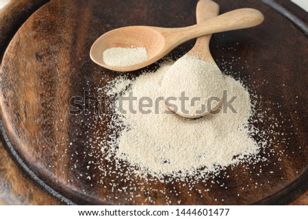 Bread yeast on wooden spoon.