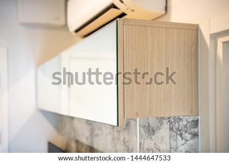 Wall mounted cupboard furniture with mirror in the front close up