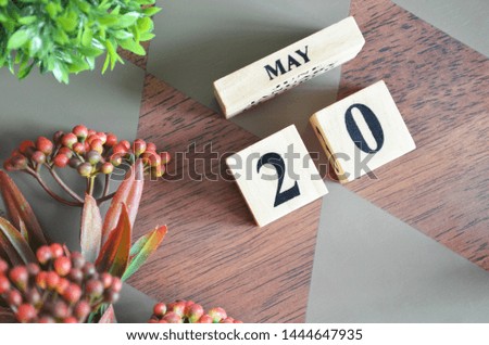Date of May month. Diamond wood table for background.