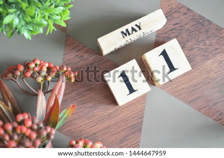 Date of May month. Diamond wood table for background.