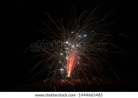 Sparklers erupting with a slow shutter speed to create light trails on 4th of July