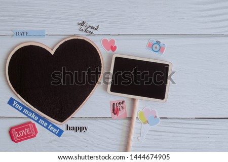 Flat lay black plain wooden tags decorate with stickers on white wooden background. Simple and minimal vintage style for frame, picture and message. Copy space for text. Love photo concept.