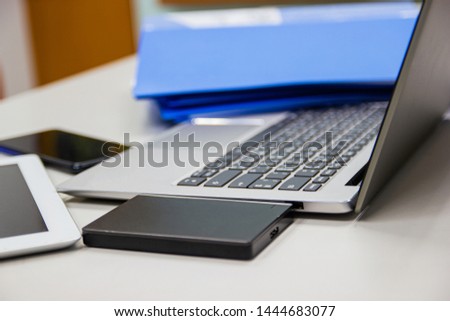 laptop computer on desk table in work office and external harddisk ,files folder , concept business life work office