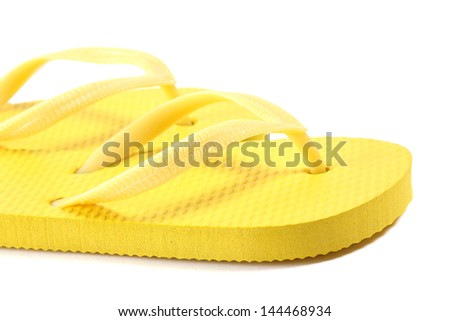 picture of yellow summer flip flops over white background