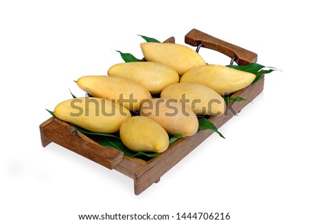 Mango tropical fruit in wooden tray on white