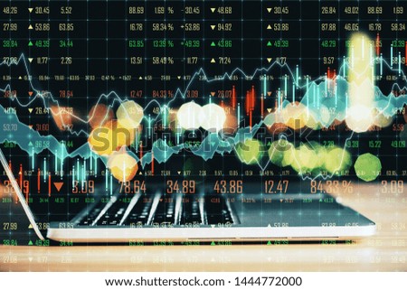 Side view of laptop with forex chart on blurry background. Analytics and finance concept. Double exposure 