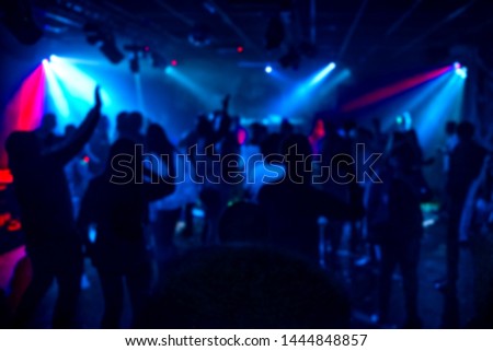 silhouettes of a crowd of people dancing in a nightclub on the dance floor at a party out of focus Royalty-Free Stock Photo #1444848857