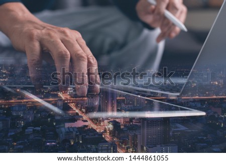 Wireless network communication, digital technology development, internet connection concept. Double exposure of man using laptop computer, digital tablet and smart city