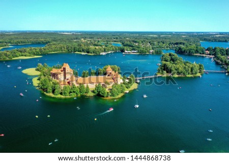 Medieval Trakai Castle, Lithuania. The castle is surrounded by many lakes and forests. A lot of yachts and boats float on the lakes. Picture taken with a drone.