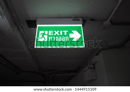 Fire exit sign in the building car park. It is the light notice.
