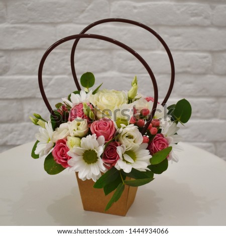 Flower composition in original box. Beautiful flowers in stylish hat box. 
Concept of flower salon. Photo for flower website or  catalog.
