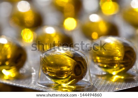Cod liver oil omega 3 gel capsules isolated on pastel background. Vitamin D capsuls. blister pack with vitamins. Pharmaceutical