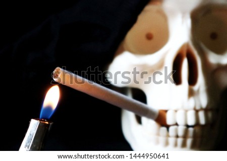 Defocused skeleton skull with a cigarette in her mouth 