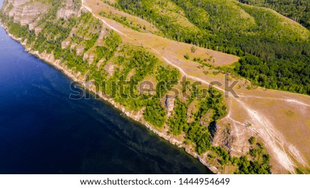 Aerial view from the drone of landscape Volga river flows among the hills and fields. The middle band of Russia.