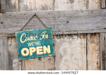 Vintage open sign on old wooden door