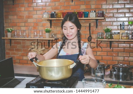 Young women make snacks in the kitchen.