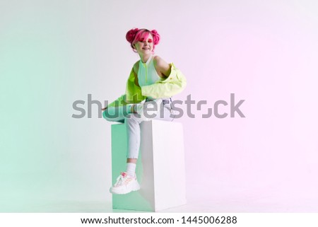 retro style eighties woman with pink hair sitting in Cuba