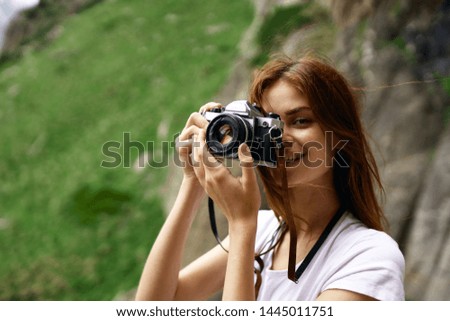 woman with camera snapshots of nature mountains