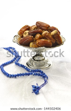 Dates in silver plate and rosary