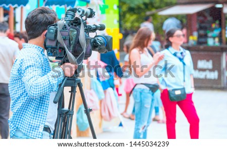 Broadcasting and Recording with Digital Camera - Cameraman Shooting Film Scene With Camera