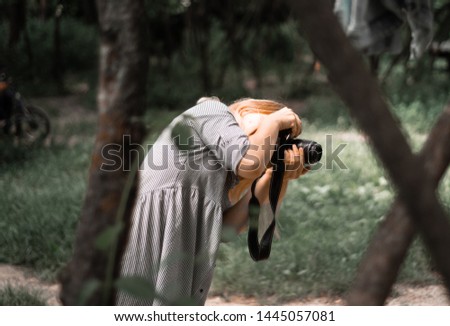 a girl with a camera in her hands 
