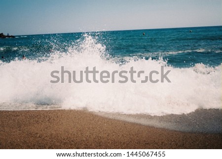 Waves crashing into the sand